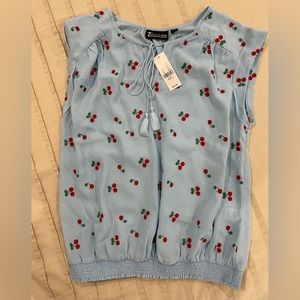 Light blue top with cherries. Brand new.